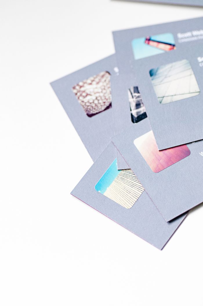 home-img A high-angle view of abstract business cards with cutout details arranged on a white background.